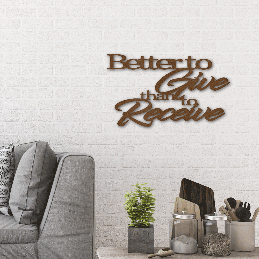 Metal wall art sign of the quote 'Better to give than to receive'. Hang this on the wall as home decor. This picture shows the design in the color copper hanging in the living room above a couch.